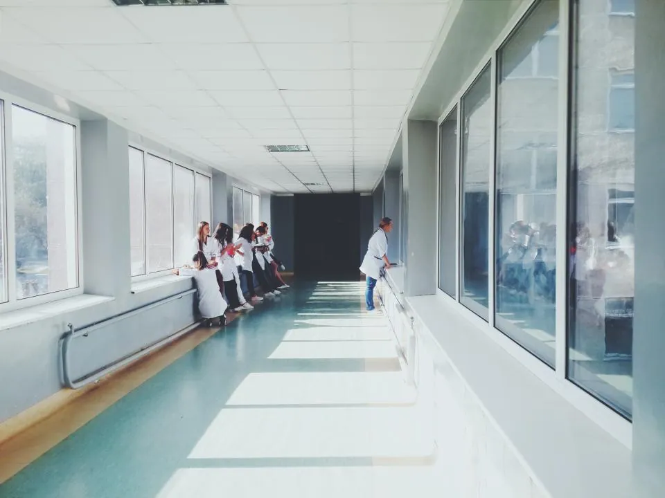 Doctors walking down a bright hospital hallway